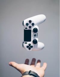 hand throwing playstation 4 controller in the air